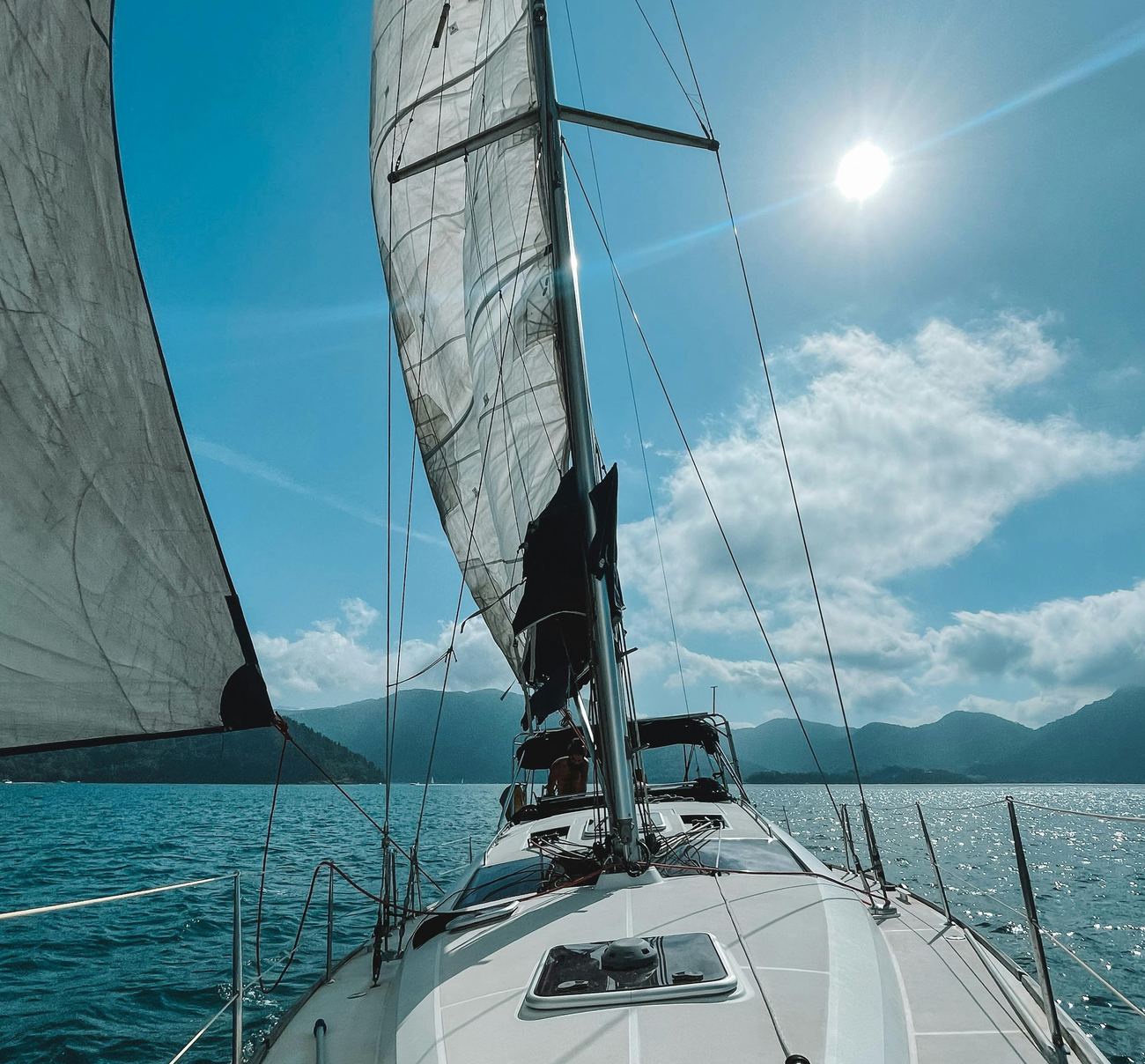 A sailing yacht under full sail on clear water